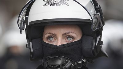 Riot police officer stands guard on the street at the Euro 2024 football tournament in Gelsenkirchen, 16 June 2024