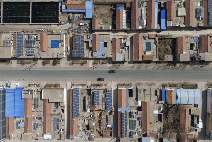 Solar panels seen on rooftops in the rural outskirts of Jinan in eastern China's Shandong province, March 2024