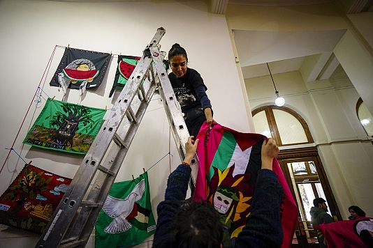 Workers prepare art from around the world for an exhibition called, "From all the rivers to all the seas. Images in solidarity with Palestine" in Santiago, Chile.