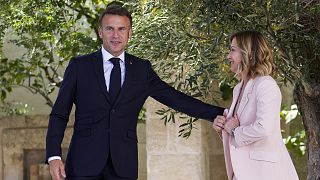 French President Emmanuel Macron, left, is welcomed by Italian Prime Minister Giorgia Meloni during a G7 world leaders summit at Borgo Egnazia, Italy, Thursday, June 13, 2024.