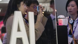 Visitors test products at the SK Telecom stand during the third day of the Mobile World Congress 2024 in Barcelona, Spain.