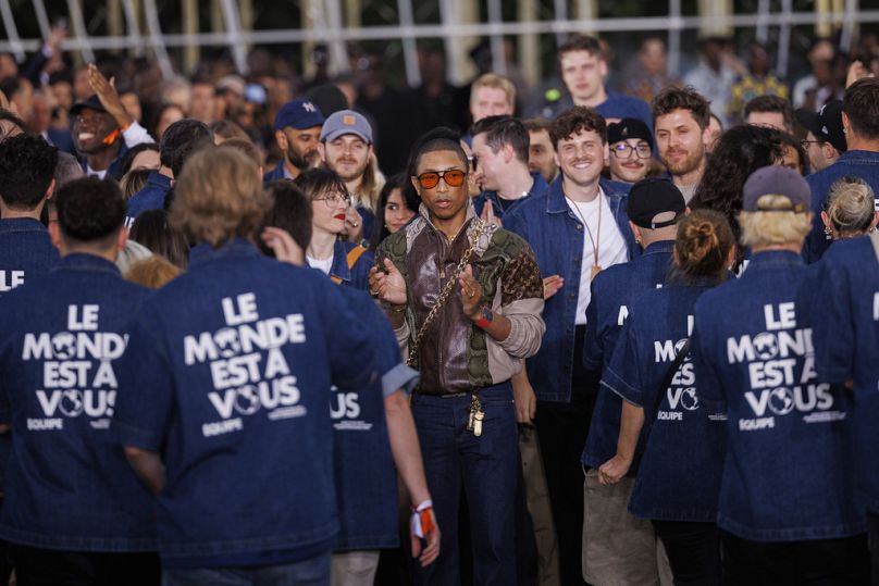 Creative director Pharrell Williams accepts applause following the Louis Vuitton Spring Summer 2025 collection