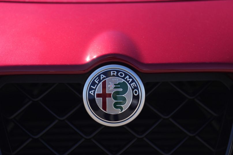 The company logo adorns the grille of an Alfa Romeo vehicle at a dealership Highlands Ranch, CO, 27 August 2023