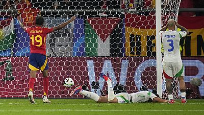 Spain's Lamine Yamal (19) celebrates after Italy's Riccardo Calafiori, center, scored an own goal