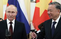 Russian President Vladimir Putin and Vietnamese President To Lam toast during a gala reception.