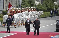 Russian President Vladimir Putin and North Korea's leader Kim Jong Un walk together during the official welcome ceremony at the Kim Il Sung Square