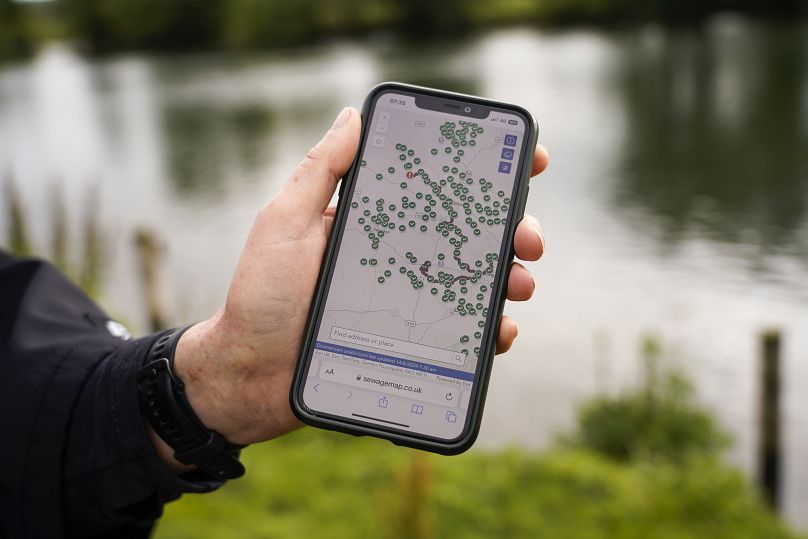 Endurance swimmer Joan Fennelly, member of the open water swimming group Henley Mermaids, shows a map of the river Thames on her smartphone, in Henley-on-Thames, England.
