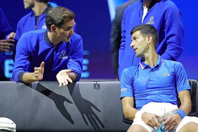 Team Europe's Novak Djokovic, right, listens to Roger Federer during a match against Team World's Frances Tiafoe.