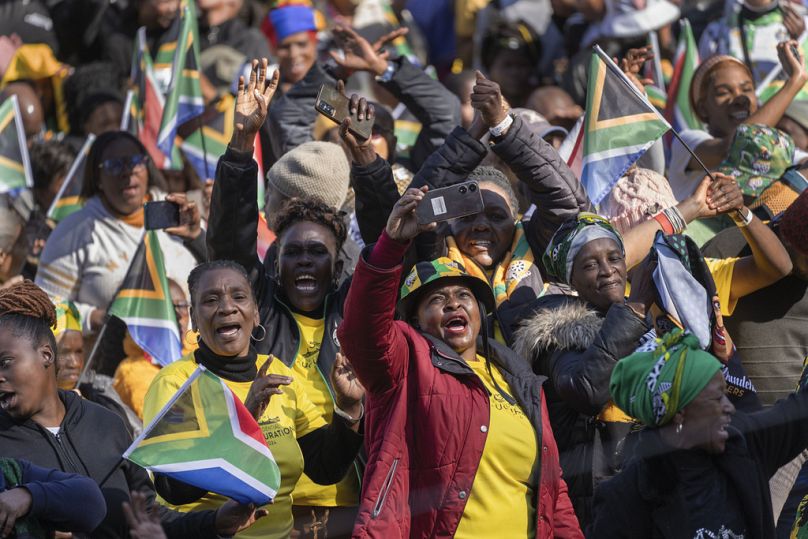 South Africans cheer ahead of the inauguration of South Africa's Cyril Ramaphosa as President at the Union Buildings South Lawns in Tshwane, South Africa, Wednesday, June 19, 