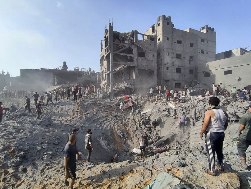 Palestinians inspect damage from Israeli airstrikes on Jabaliya refugee camp on the outskirts of Gaza City shortly after the start of Israel's offensive in October 2023.