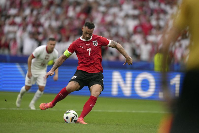 Austria's Marko Arnautovic (7) scores from the penalty spot during a Group D match between Poland and Austria