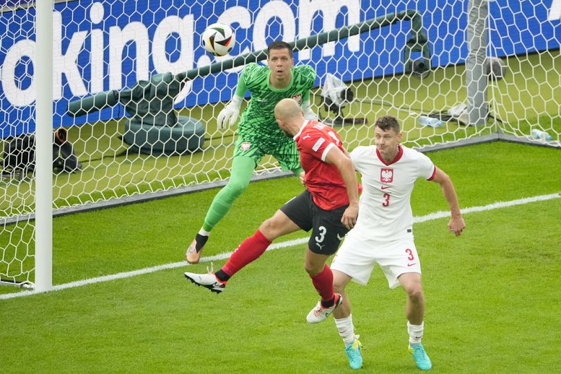 Austria's Gernot Trauner, left, scores the opening goal during a Group D match between Poland and Austria 