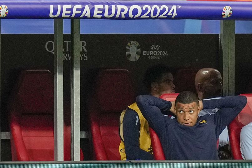 France's injured Kylian Mbappé watches on from the bench as France take on the Netherlands