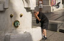 A man cools himself at a public fountain in Belgrade, 21 June 2024