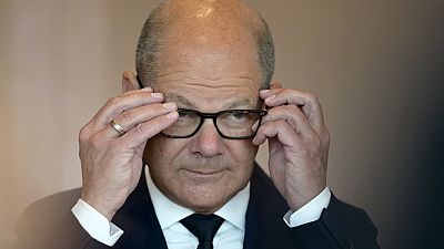 Chancellor Olaf Scholz adjusts his glasses as he arrives for the cabinet meeting in the Chancellery in Berlin, Germany, Wednesday, June 19, 2024