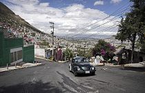 A 1996 Volkswagen Beetle is drivn up a steep hill in the Cuautepec neighborhood of Mexico City