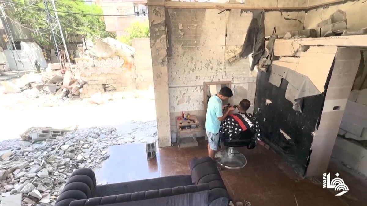 Gaza barber continues working in salon, surrounded by rubble thumbnail