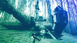 A Ukrainian soldier from 57th brigade looks out from a Swedish Combat Vehicle 90 near front line in Kharkiv region, 18 June 2024