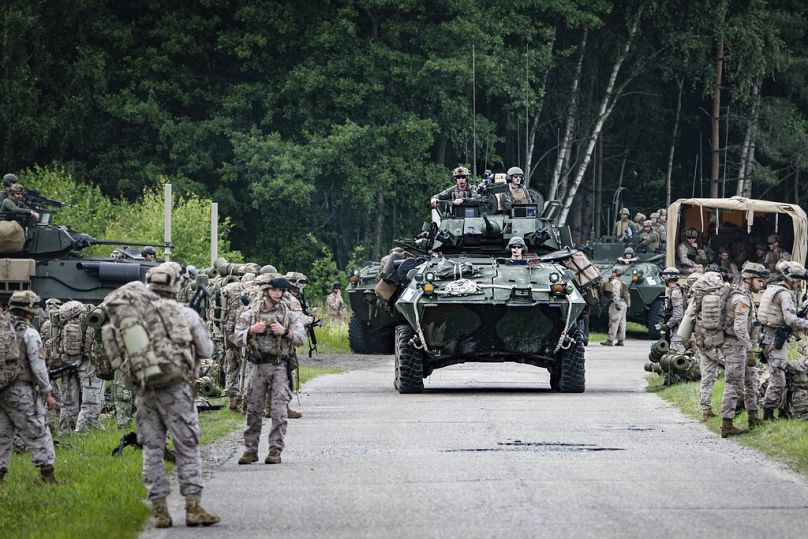 Military armored vehicles take part in the Baltops 2024 exercise in the Baltic Sea region.
