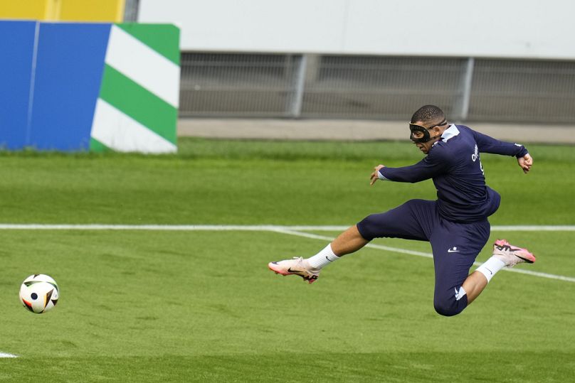 France's Kylian Mbappe attempts a shot during a training session in Paderborn, Germany, Sunday, June 23, 2024