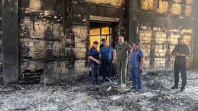 The head of Dagestan Republic Sergei Melikov, center, visits the damaged Kele-Numaz synagogue in Derbent after a counter-terrorist operation in republic of Dagestan, Russia. 
