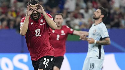 Georgia's Georges Mikautadze celebrates after scoring on a penalty kick during a Group F match between Georgia and Portugal at Euro 2024