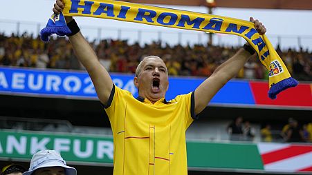 A Romanian fan cheers at the end of Group E match at the Euro 2024
