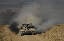 Israeli soldiers drive a tank near the Israeli-Gaza border, in southern Israel, 5 June 2024