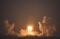 In this photo by China's Xinhua News Agency, a Long March-5 rocket, carrying the Chang'e-6 spacecraft, blasts off from its launchpad at the Wenchang Space Launch Site.