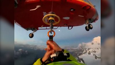 Body camera footage of rescuer descending from helicopter to save three Polish mountaineers 