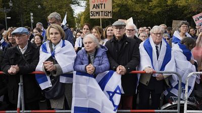 People listen to speeches during a demonstration against antisemitism in Berlin.