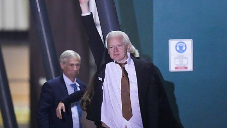 WikiLeaks founder Julian Assange waves after landing at RAAF air base Fairbairn in Canberra, Australia, Wednesday, June 26 2024.
