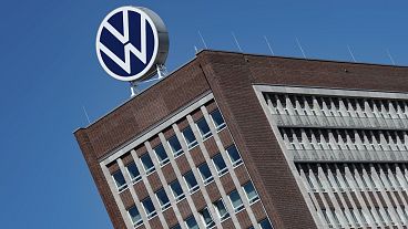 The Volkswagen logo stand on the top of a VW headquarters building in Wolfsburg, Germany,