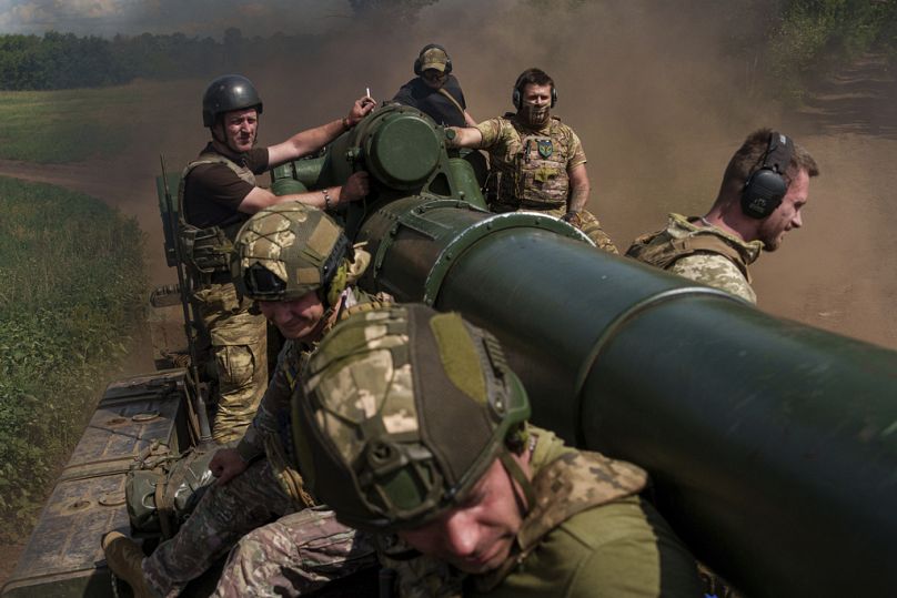 Ukrainian soldiers of 43rd artillery brigade ride atop on 2s7 self-propelled howitzer before firing towards Russian positions at the frontline in Donetsk region.