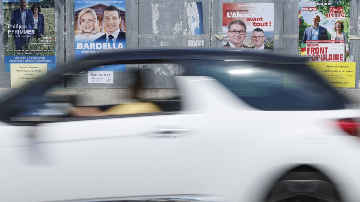 A car drives past electoral posters, Thursday, June 27, 2024 in Strasbourg, eastern France.
