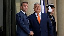 French President Emmanuel Macron, left, shakes hands with Hungarian Preme Minister Viktor Orban before a working lunch.