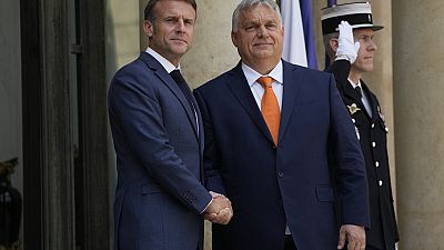 French President Emmanuel Macron, left, shakes hands with Hungarian Preme Minister Viktor Orban before a working lunch.