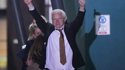 WikiLeaks founder Julian Assange gestures after landing in Canberra, Australia