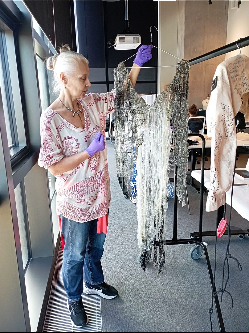 Helen Storey holds aloft the remains of the 'Disappearing' dress