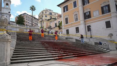 Rome municipality workers clean the Spanish Steps after activists dumped red paint over them protesting against violence on women