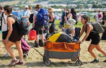 Festival goers arrive at the Glastonbury Festival in Worthy Farm, Somerset, England, Wednesday, June 26, 2024.