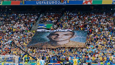The banner of a fallen military paramedic was unfolded during a Ukraine-Belgium game. 