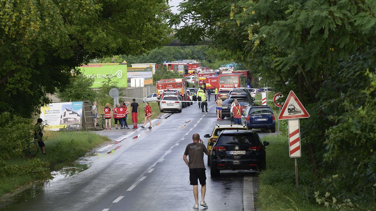 Firefighters and emergency vehicles near the scene of the train and bus crash in train collide in Nové Zámky, June 27, 2024
