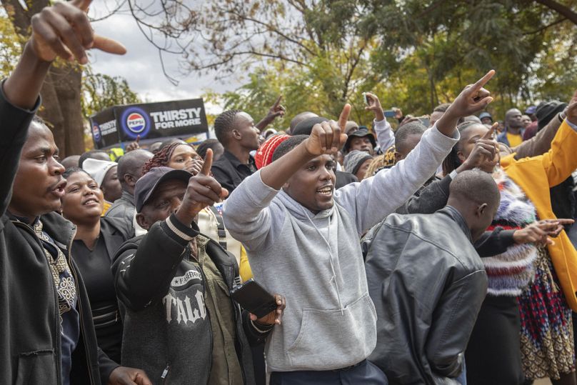 Opposition supporters protest outside a court, in Harare, Zimbabwe, Thursday, June 27, 2024. 
