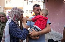 Palestinian parents say goodbye to their sick son before leaving the Gaza Strip to get treatment abroad through the Kerem Shalom crossing