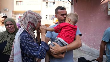 Palestinian parents say goodbye to their sick son before leaving the Gaza Strip to get treatment abroad through the Kerem Shalom crossing