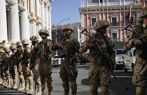Soldiers block the street in front of the presidential palace, right, and the Legislative Assembly, left, in Plaza Murillo in La Paz, 26 June 2024