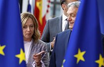 Hungary's Prime Minister Viktor Orban, right, speaks with Italy's Prime Minister Giorgia Meloni prior to a group photo at an EU summit in Brussels, Thursday, June 27, 2024.
