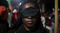 An abortion rights activist with a band over her eyes protests an anti-abortion bill in Congress