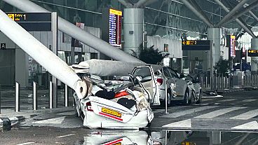 Parked vehicles are damaged by the collapse of a departure terminal canopy at New Delhi's Indira Gandhi International Airport following heavy pre-monsoon rains